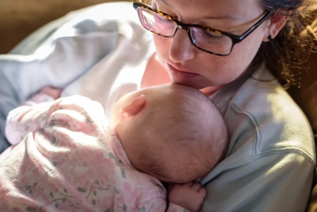 tired new mom catching up on sleep while baby is n 2024 10 11 19 37 44 utc